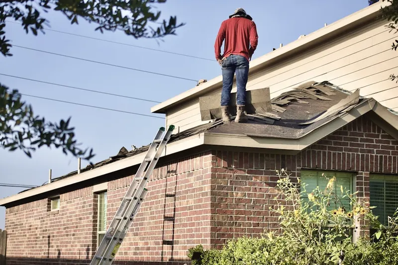 Professional roofer working on a residential roof in Foggy Bottom